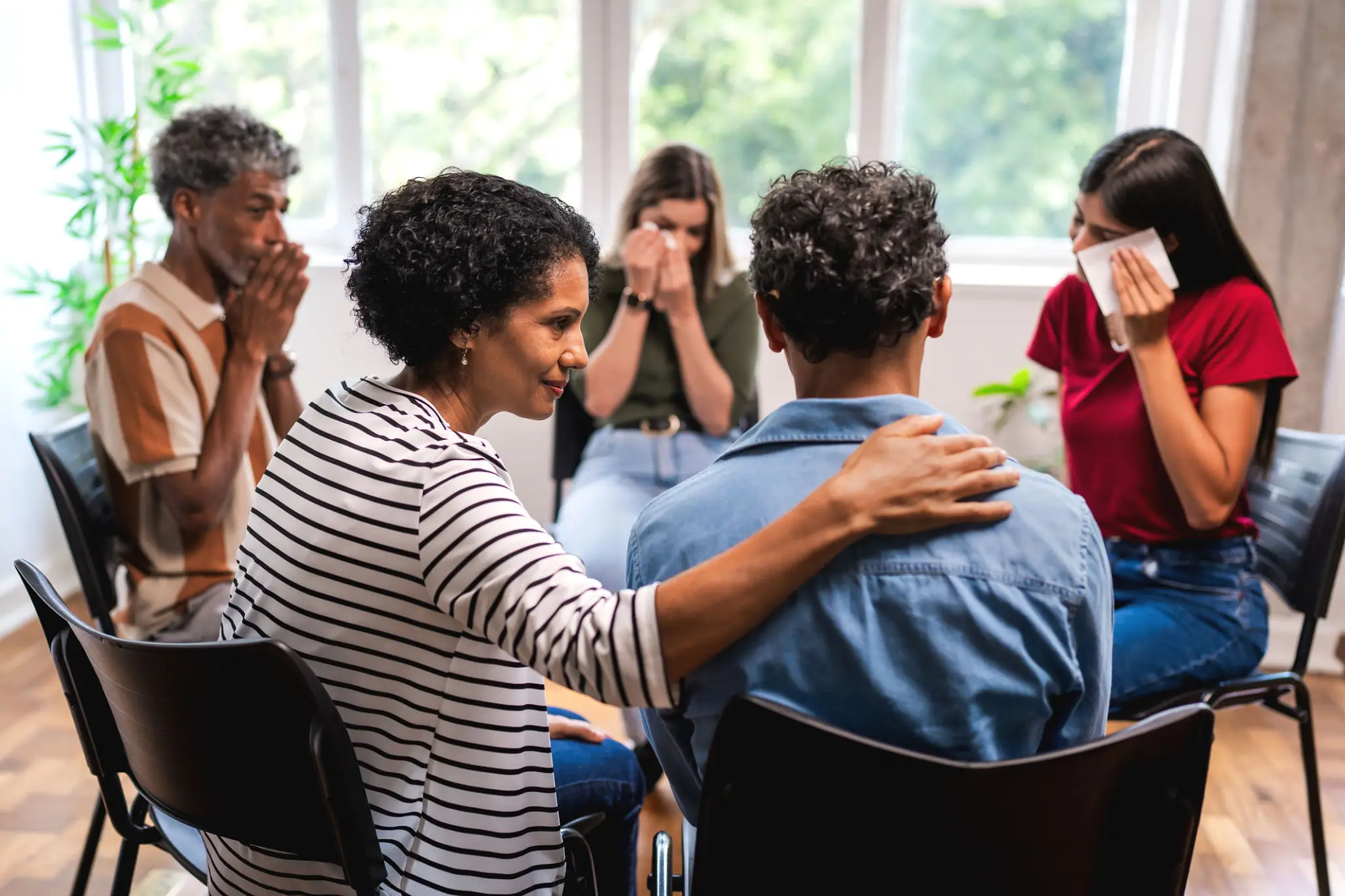 People in emotional group therapy session