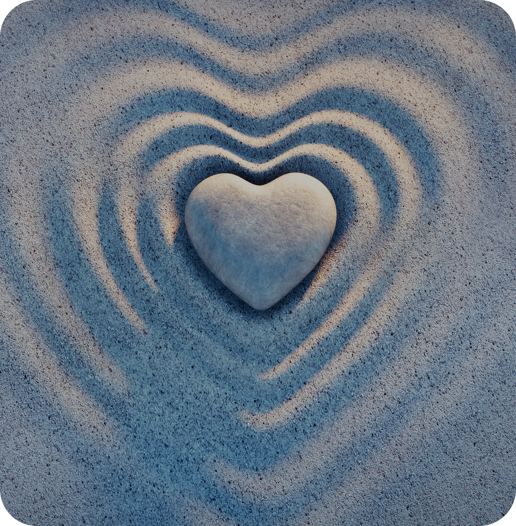 Stone heart on textured sand