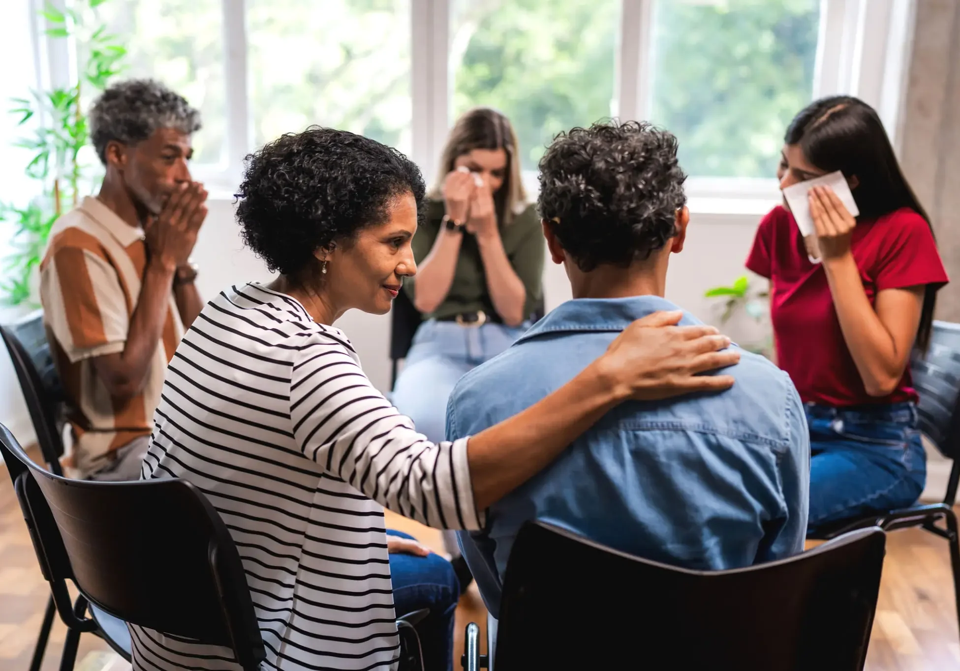 People in emotional group therapy session